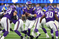 Sam Darnold #14 of the Minnesota Vikings prepares a handoff during a 30-20 loss to the Los Angeles Rams