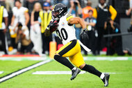 Jaylen Warren of the Pittsburgh Steelers running with a football.