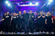 The SNL cast and Michael Keaton onstage in 2015