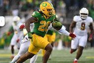 Jordan James, of the Oregon Ducks, running with the ball during a game.