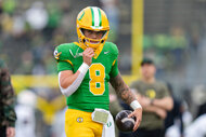 Quarterback Dillon Gabriel of the Oregon Ducks warms up before a game