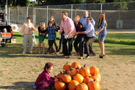 The cast of Modern Family during a game of tug of war on modern family season 3 episode 9