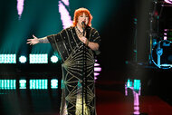 Lauren-Michael Sellers sings on stage on The Voice Season 26 Episode 16