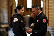 Kelly Severide and Stella Kidd stand together at a funeral on Chicago Fire Season 7 Episode 7