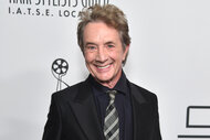 Martin Short smiles in a black suit on the red carpet