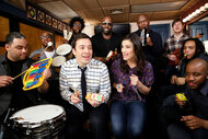 Idina Menzel and Jimmy Fallon singing with a band using classroom instruments.