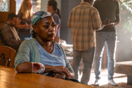 Betsy Chase (Karen Robinson) sitting at a table in Brilliant Minds Season 1, Episode 12.