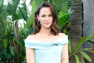 Jennifer Garner smiles in front of greenery at an event