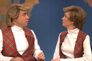 Fred Armisen and Kristen Wiig sit at the weekend update desk together on Saturday Night Live