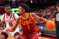 Desmond Claude #1 of the USC Trojans defends the ball from a Rutgers Scarlet Knights player