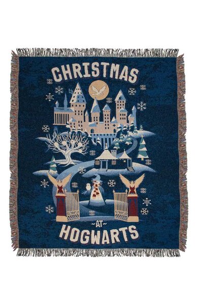 A blue woven throw blanket with Hogwarts in the middle.