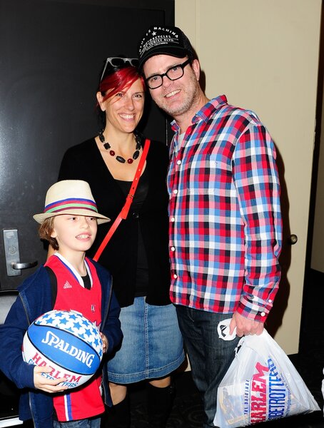 Rainn Wilson poses with wife Holiday Reinhorn and son Walter Mckenzie Wilson all wearing coordinating red and blue.