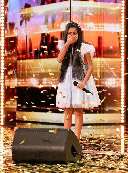 Pranysqa Mishra stands in shock as golden confetti rains down on America's Got Talent Episode 1905.