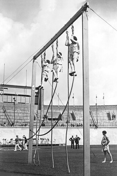 The french womens gymnastics team during the 8 meter rope climb at the 1928 olympics