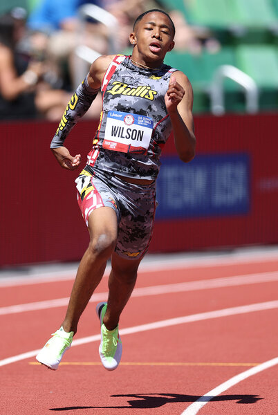 Quincy Wilson running during a 400 meter race on a track.