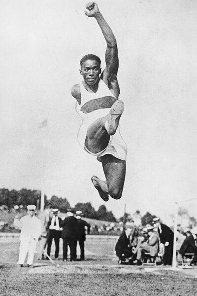 William Dehart Hubbard jumping during a track and field event