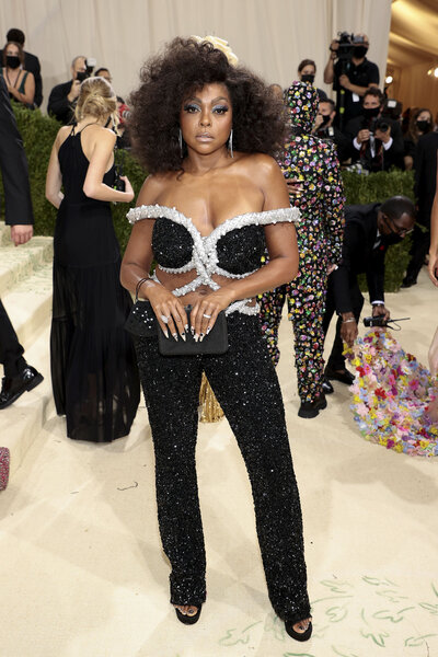 Taraji P. Henson wearing a jewel encrusted jumpsuit on a red carpet at the 2021 Met Gala.