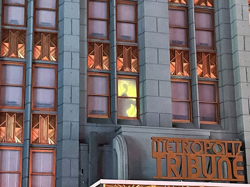 A figure standing in a lit up window at Halloween Horror Nights.