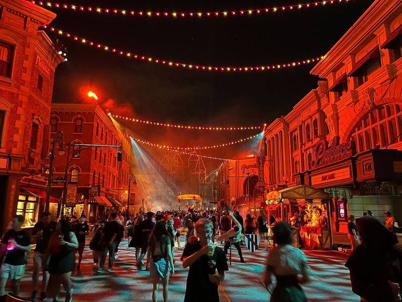 Guests walking around Halloween Horror Nights outdoors.