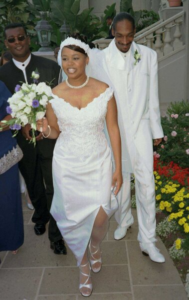 Snoop Dogg and Shante Broadus match in white at their wedding.