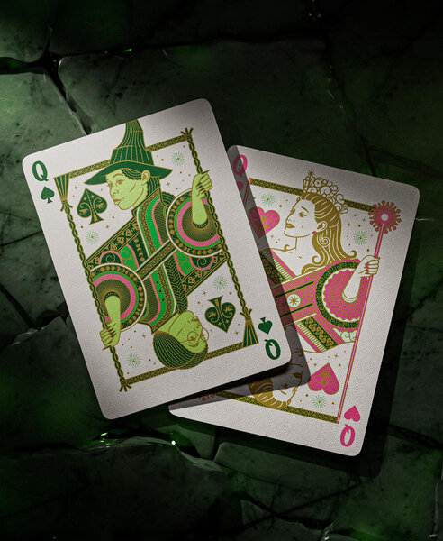 two playing cards one is green with Elphaba and one is pink with Glinda on it