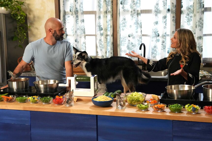 Adrian Stoica, Hurricane, and Cat Cora appear in a kitchen setting with food surrounding them.