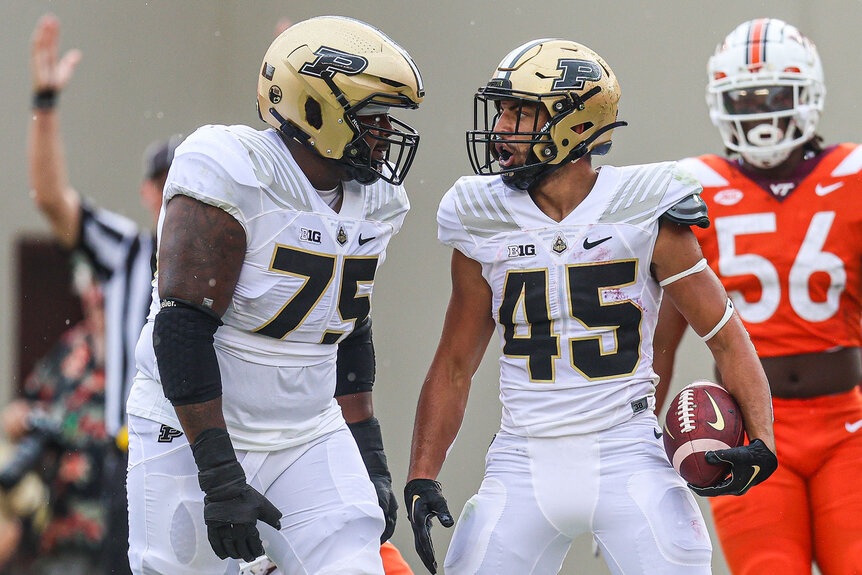 Jalen Grant #75 and Devin Mockobee #45 of the Purdue Boilermakers celebrate together after a touchdown