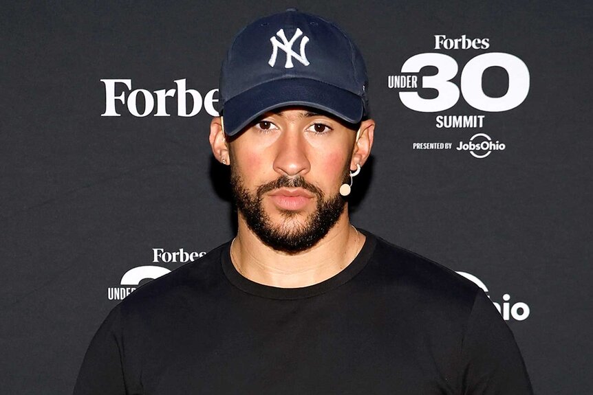 Bad Bunny attends an event wearing a yankees hat