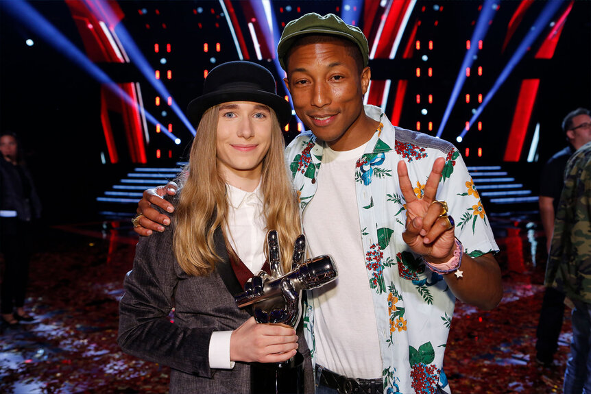 Swayer Fredericks and Pharrell pose for a photo together on The Voice stage