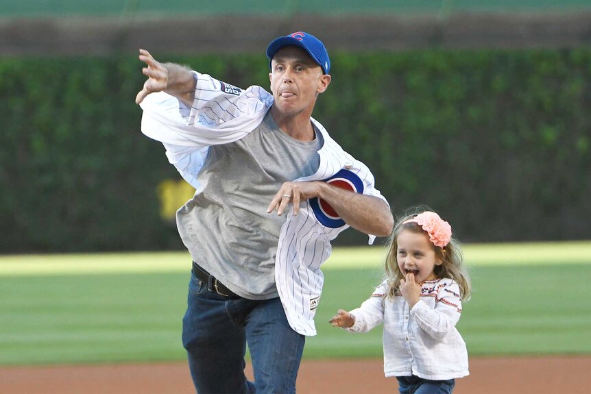 David Eigenberg with his daughter throw the first pitch the Chicago Cubs game