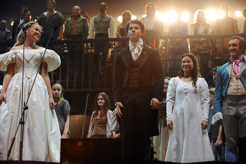 Nick Jonas stands onstage during a performance of 'Les Miserables'