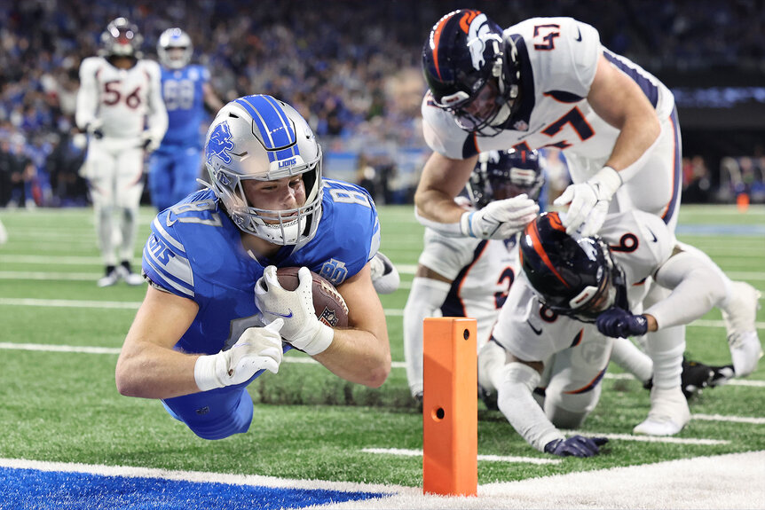 Sam LaPorta of the Detroit Lions dives into the endzone for a touchdown