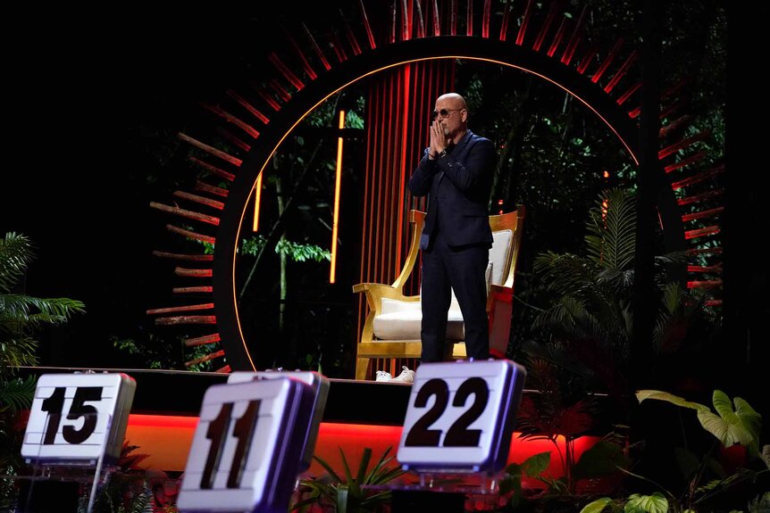 Howie Mandel holds his hands up to his head with concern on Deal or No Deal Episode 112.