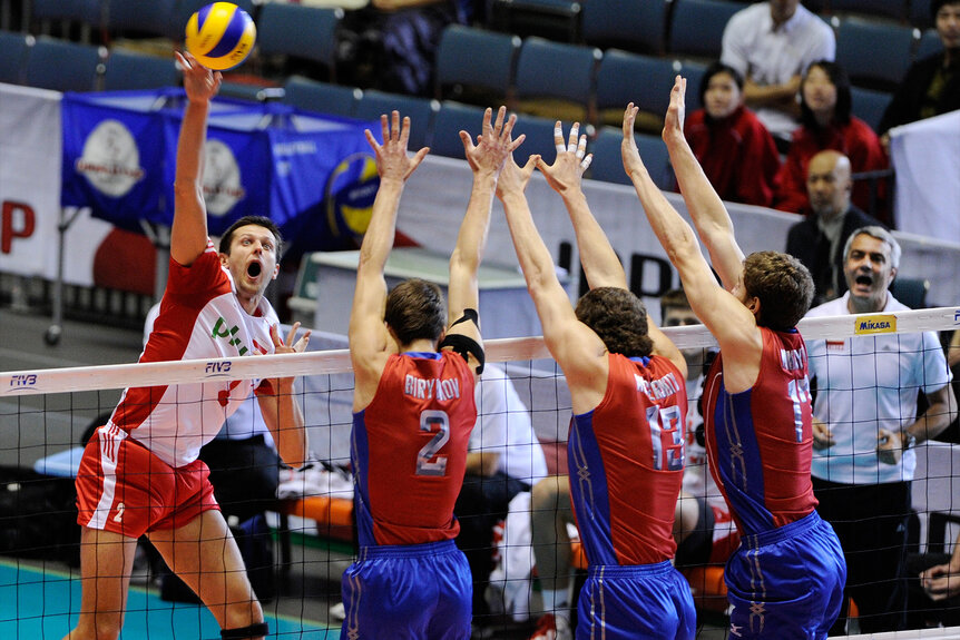 Michal Winiarski of Poland spikes the ball at the Russian team in a volleyball tournament at the 2011 Men's World Cup.