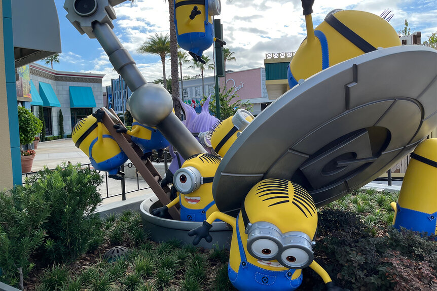 A statue of Minions building things at Minions Land