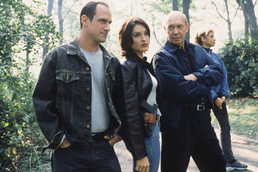 Detective Elliot Stabler, Detective Olivia Benson, and Captain Donald Cragen stand outside in Law & Order: Special Victims Unit Episode 108.