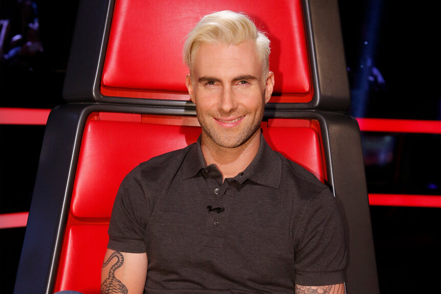 Adam Levine sits in his chair on The Voice Season 6