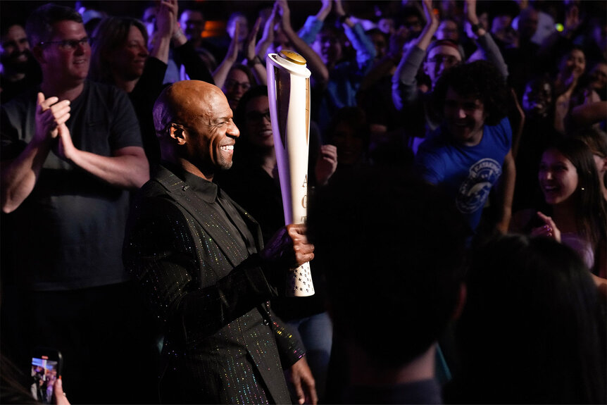 Terry Crews carries the Olympic Torch during America's Got Talent Season 19 Episode 8.