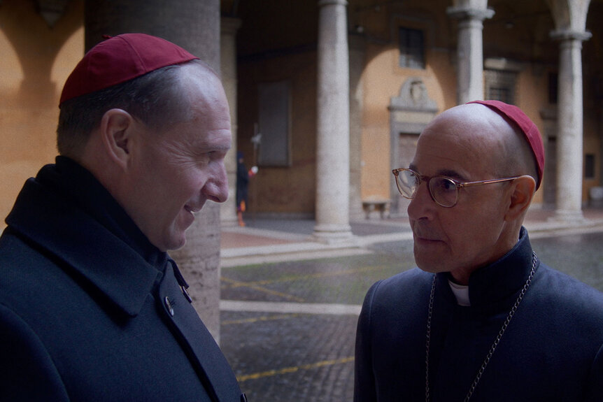 Ralph Fiennes as Cardinal Lawrence and Stanley Tucci as Cardinal Bellini in director Edward Berger's CONCLAVE.