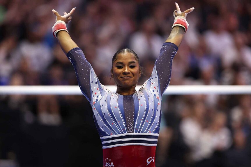 Jordan Chiles raises her arms at the 2024 U.S. Olympic Gymnastics Trials.