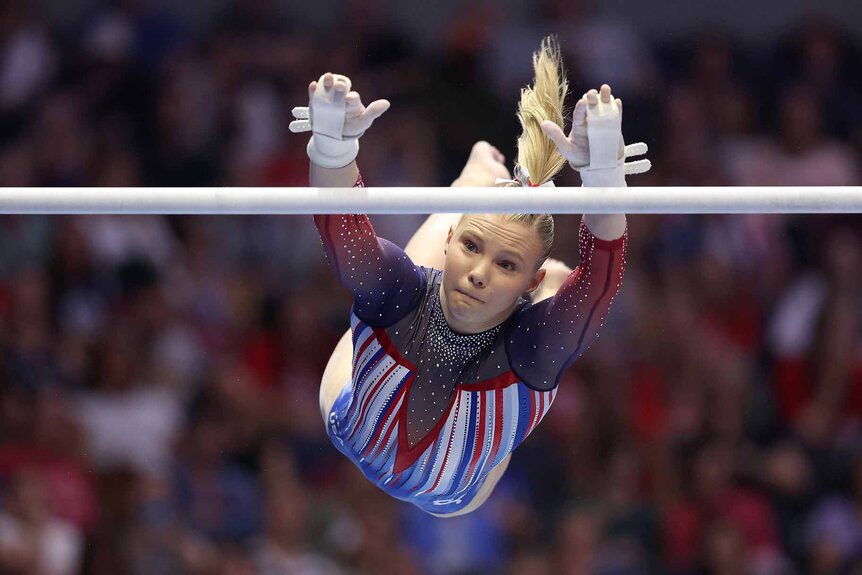 Jade Carey competes on the uneven bars.