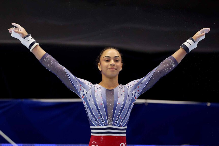 Hezly Rivera raises her arms at the 2024 U.S. Olympic Gymnastics Trials.