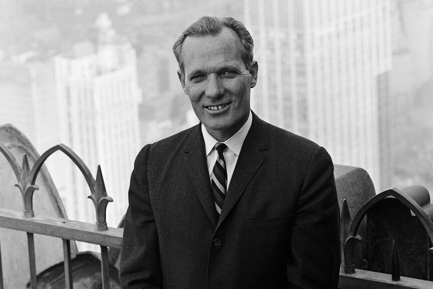 Nightly News anchor Frank McGee poses on the top of building