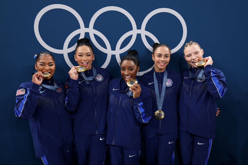 Gold medalists Jordan Chiles, Sunisa Lee, Simone Biles, Hezly Rivera and Jade Carey of Team United States pose with the Olympic Rings