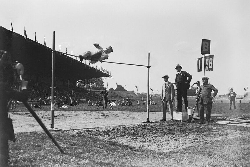 American athlete Harold Osborn attempts to clear the bar in the final of the men's high jump event at the 1924 Summer Olympics