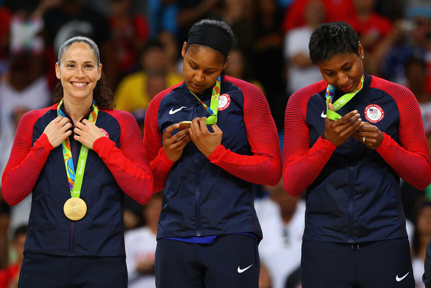 Gold medalists Sue Bird, Maya Moore and Angel Mccoughtry celebrate during the medal ceremony after the Women's Basketball competition on Day 15 of the Rio 2016 Olympic Games