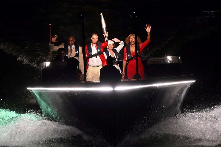 Past Olympians sail on a boat in the Siene at the 2024 Olympic Opening Ceremony 1