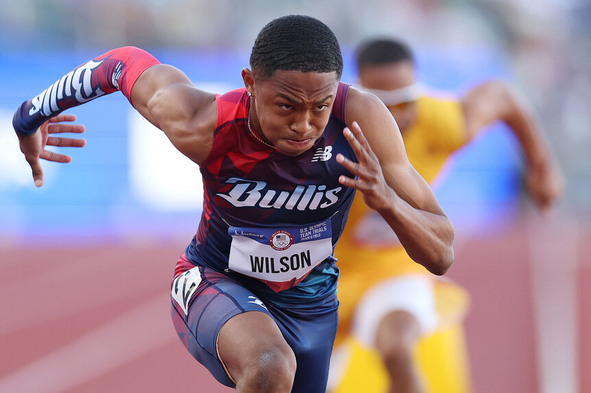 Quincy Wilson running during a 400 meter race on a track.