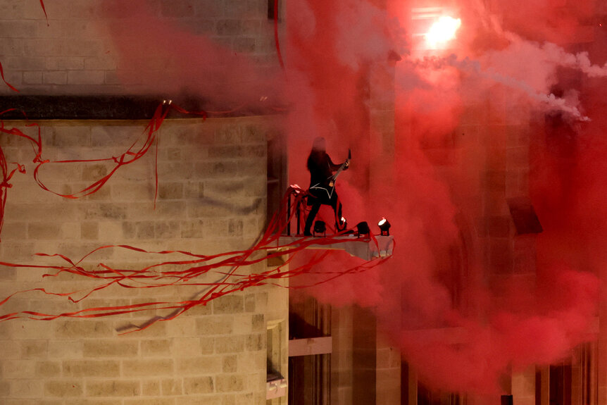 A rock band performs during the 2024 Olympics Opening Ceremony