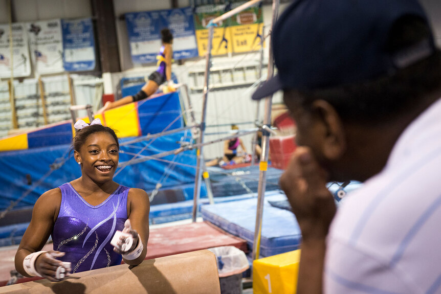 Simone Biles talks with her father Ron Biles as she trains at Bannon's Gymnastix